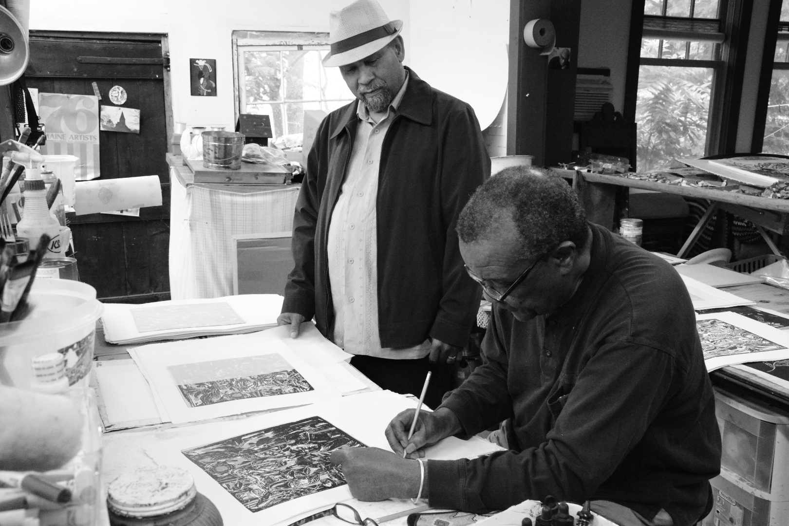 David C. Driskell signing a print with Curlee R. Holton
