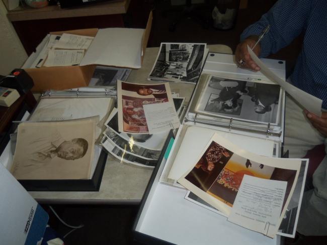 Old photos of Professor Driskel scattered on table